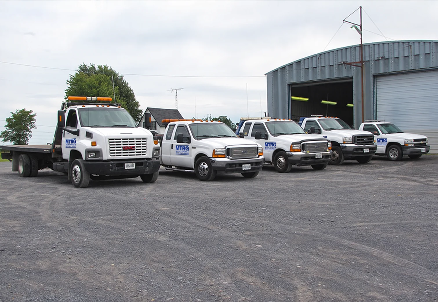 Metro Towing and Recovery Group fleet outside a service garage