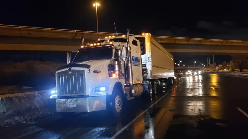 MTRG tractor and trailer on a wet highway at night