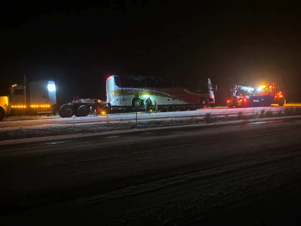 MTRG heavy recovery equipment transporting a coach bus at night