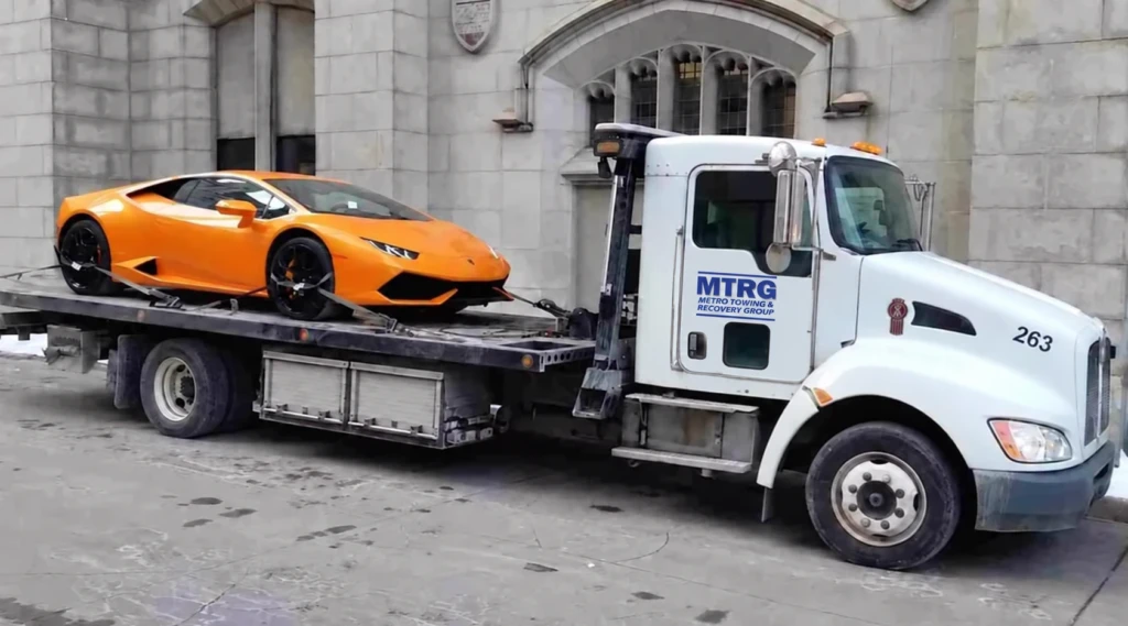 MTRG flatbed transporting an orange sports car