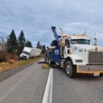 MTRG heavy wrecker recovering a truck from a roadside ditch